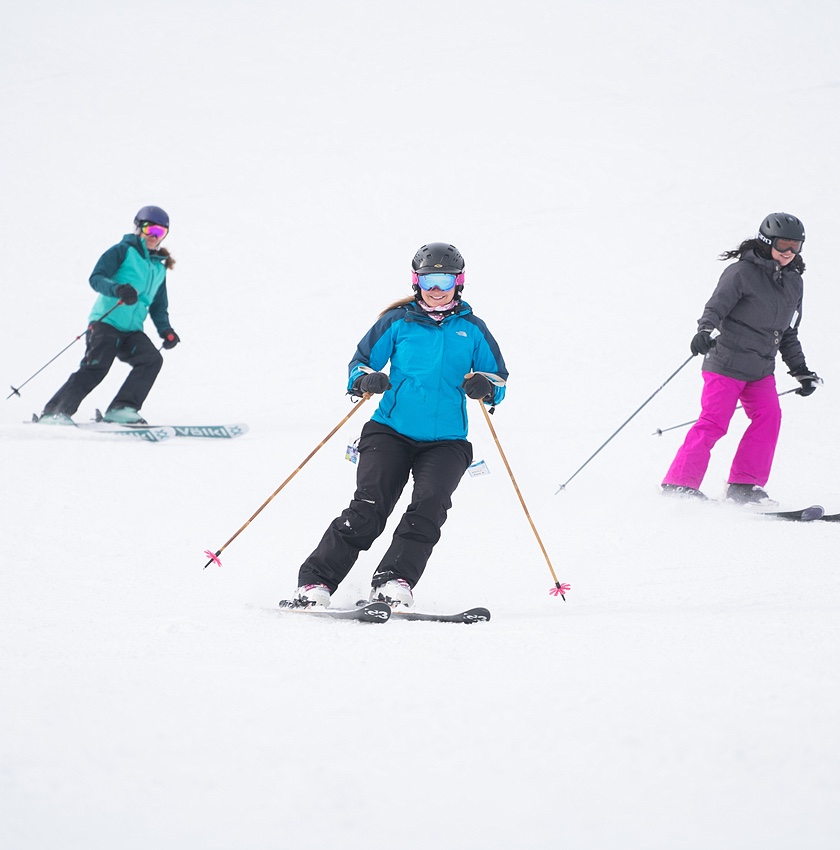 three parents skiing at showdown montana